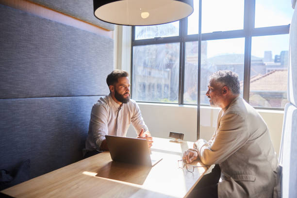 istock Businessman talking during a meeting together in an office cubicle 1477483746