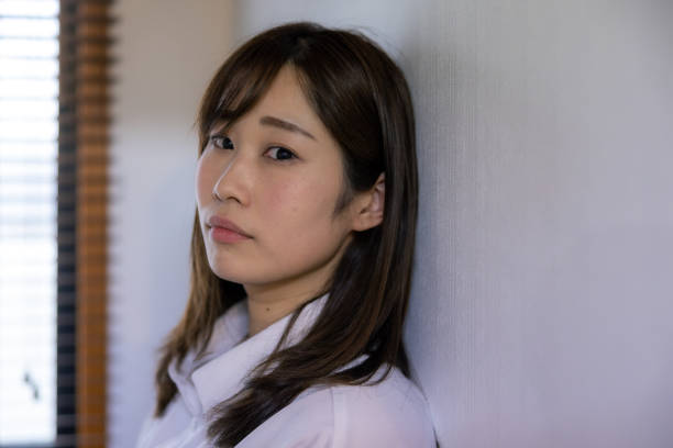 istock Female patient leaning on wall, looking at camera 1477485449