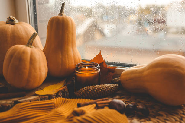 istock Thanksgiving autumn decor, burning candle, pumpkins and candles 1477485559