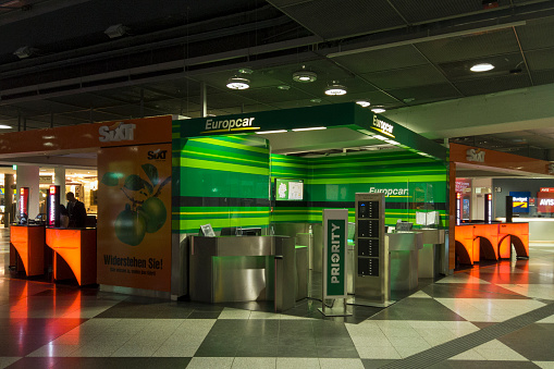 Baggage claim with airport directional signs above