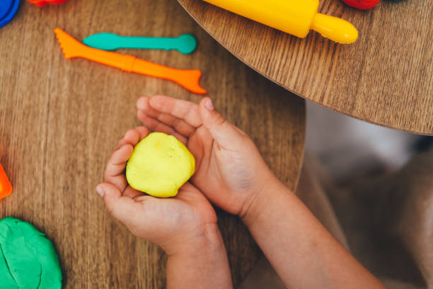 istock The child holds plasticine in his hands. Modeling workshop concept 1477486216