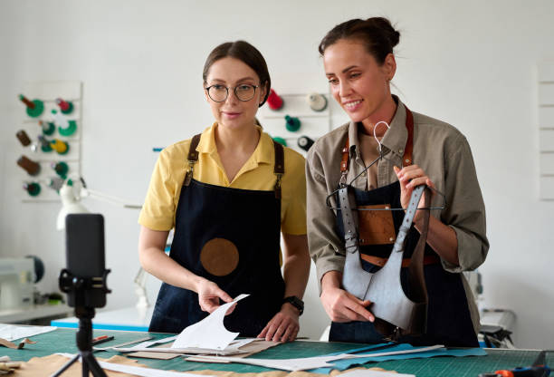 istock Young tanner showing handmade leather attire to online audience 1477487749
