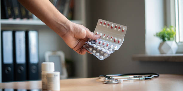 istock Woman's hand holding medicine packs 1477487807