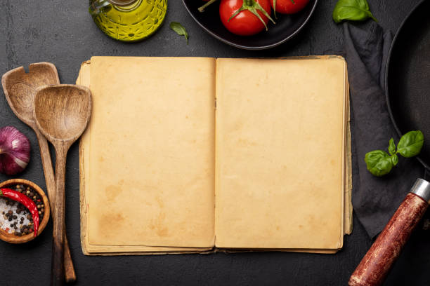 istock Top-down view of a kitchen table with ingredients, utensils, and an open cookbook 1477490099