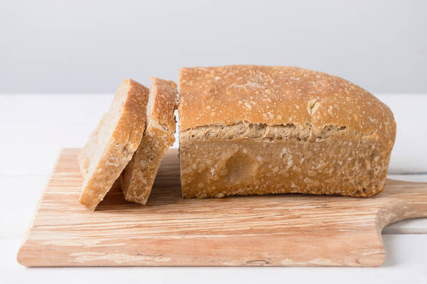 sliced loaf of white sourdough bread on light background - home made bread imagens e fotografias de stock