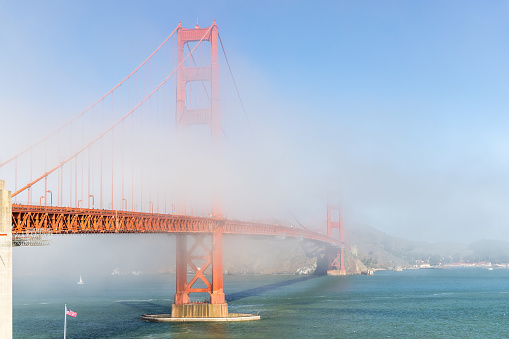 The golden gate bridge peaking through the dense San Francisco Bay Area fog.