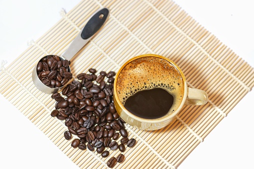 Special menu espresso coffee and the beans around put on the bamboo pattern ready for drinks with white background.