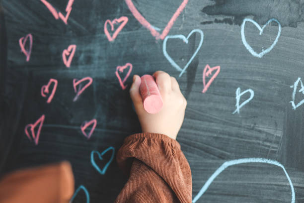 istock The child draws hearts on the board 1477492498