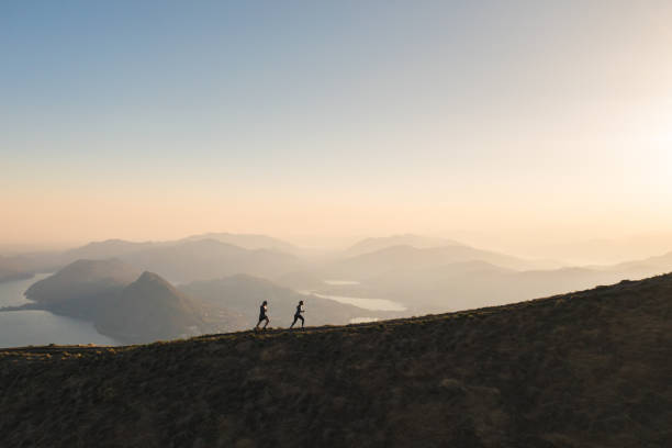 istock Aerial view of trail runners ascending mountain ridge 1477494875