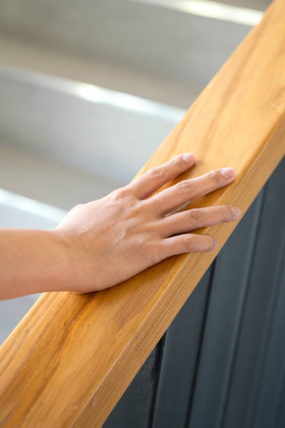 istock Holding the handrail during walking up the stair. 1477496120