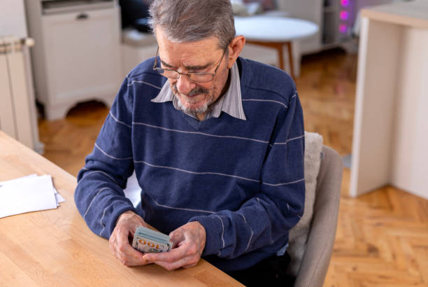 istock Senior man counting money 1477498841