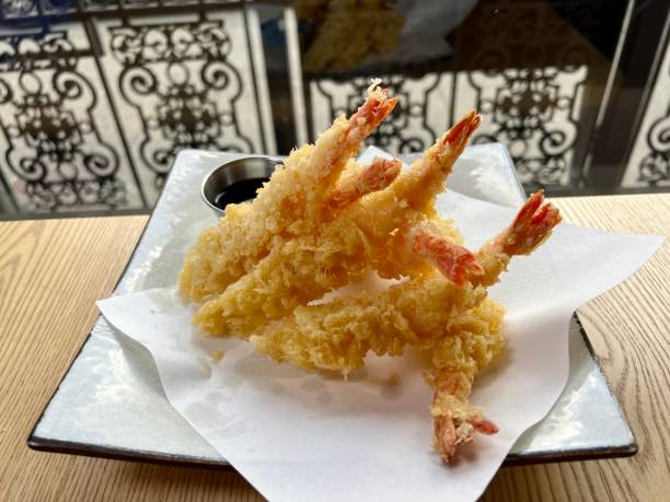 istock fried shrimps or prawns with sauce Fried Shrimp in batter on plates with lemon 1477501827