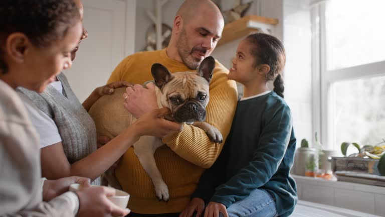 Family and boy with Down syndrome giving dog treats