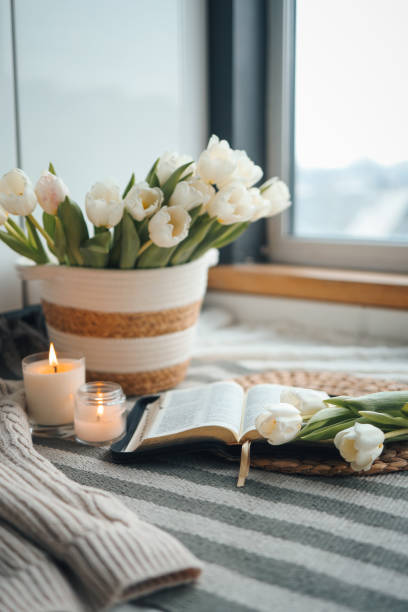 istock Bible, tulips and candles, cozy home atmosphere 1477502922