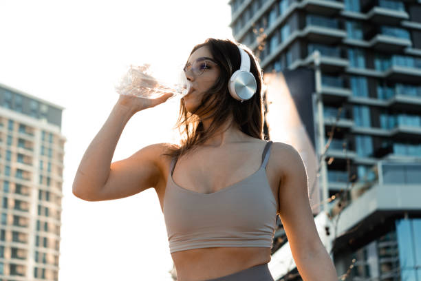 istock Girl enjoying music and refreshing while jogging 1477506523
