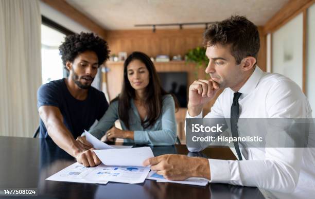 Financial Advisor Talking To A Couple About Their Business Plan Stock Photo - Download Image Now