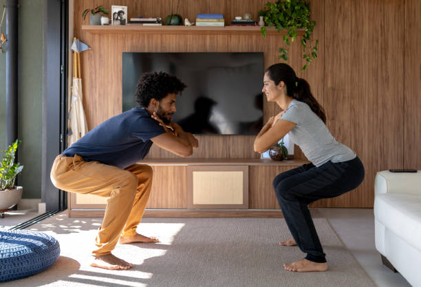 istock Happy couple working out together at home 1477508351