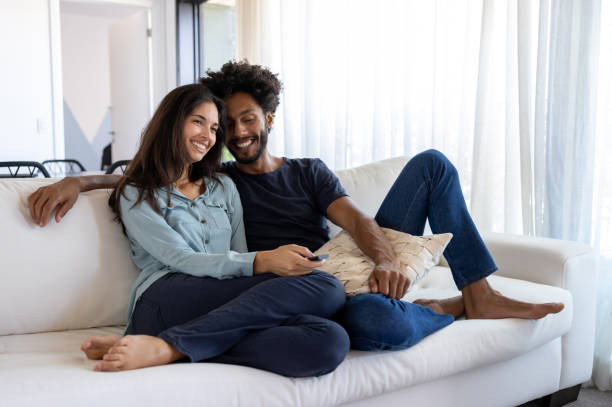 istock Loving couple on a romantic date watching television at home 1477508385