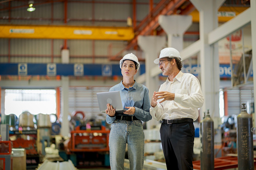 A new generation of engineers in a metal sheet factory.  Studying work methods from supervisors or colleagues and studying by yourself  be taught professionally