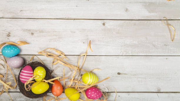 easter eggs painted in pastel colors on white wooden background. easter concept - easter text single word paint imagens e fotografias de stock