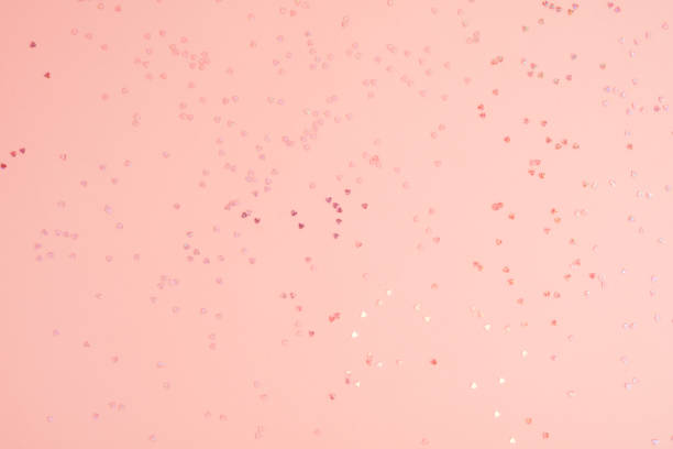 istock Pink pastel background with small hearts confetti. Flatlay, top view, copy space 1477510216