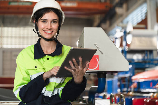 istock Portrait engineer woman use tablet computer working with machine at metal sheet factory 1477510295