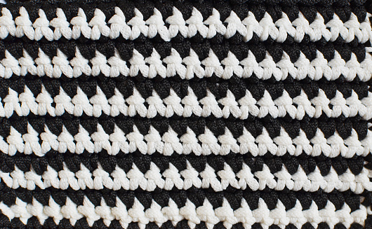 Black and white horizontal stripes - crocheted texture background, concept of contrast in life, ups and downs. Black and white streaks in life. Handmade background