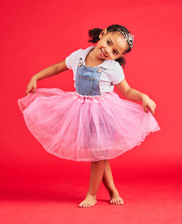 Dance, child and curtsy in princess dress, fantasy and red background on studio mockup. Happy kids holding ballerina skirt, fairytale clothes and fashion crown with smile, play and girly happiness