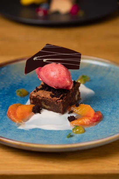 istock Brownie dessert cake with orange slices and raspberry ice cream 1477513897