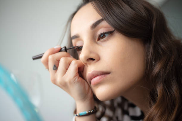istock Young woman is doing a make-up. 1477514064
