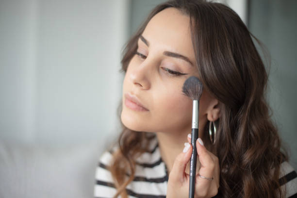 istock Young woman is doing a make-up. 1477514262