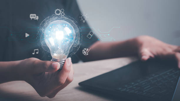 istock Artificial intelligence machine learning concept. Human hand hold digital brain of AI in light bulb be a help think creativity idea Music, Movie, Chat bot. Analytics big data around the world. 1477516444