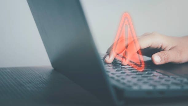 istock Triangle caution warning sign on laptop screen and Businessman or it staff , programmer, developer using computer for notification problem error 404 and maintenance concept. 1477517296
