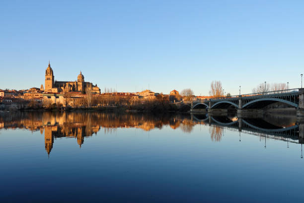daytime view of the Salamanca skyline and its reflection on the Tormes river ( Spain).