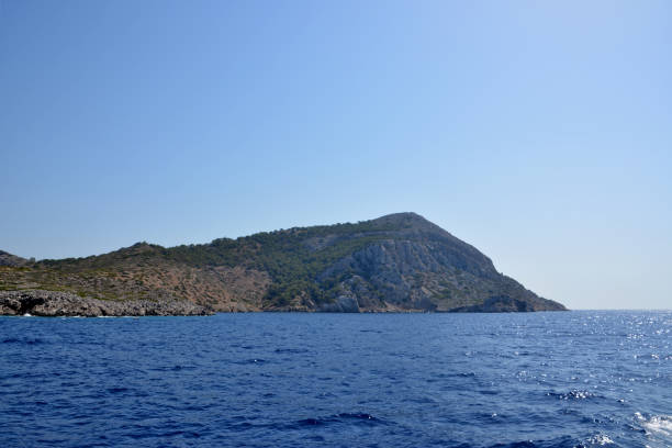 istock The island with mountain isolated with blue sea on foreground, copy space 1477520209