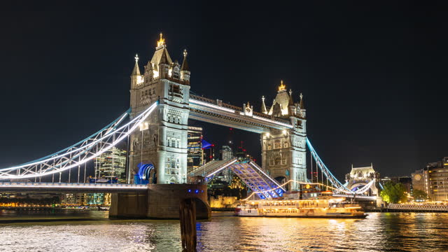 Time lapse of Tower bridge Lifting the drawbridge for nautical vessel passing through the river thames at night in London United Kingdom,