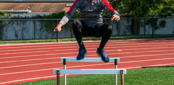 istock Athlete above a hurdle jumping over hurdles at practice 1477521623