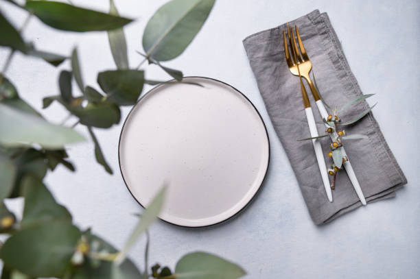 istock Festive table setting for a spring celebration, wedding, birthday or mother's day with eucalyptus branches on a light background. The concept of the restaurant menu. 1477521984