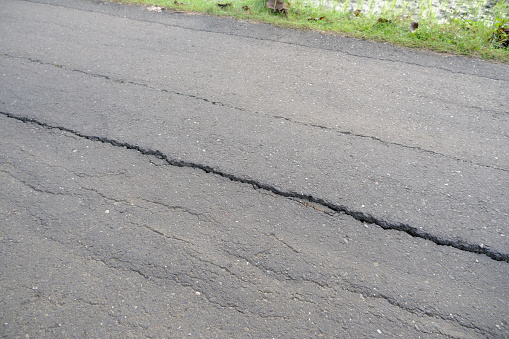 Crack along asphalt road because of erosion