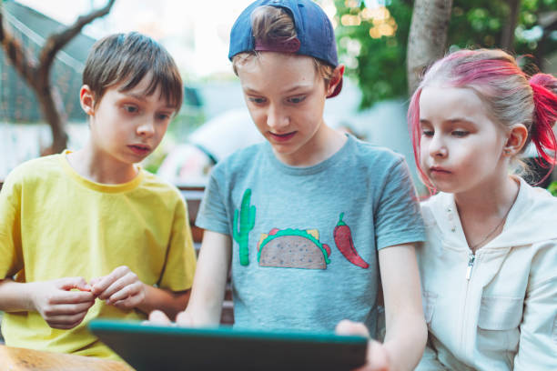 istock Three children playing games at digital tablet 1477523660