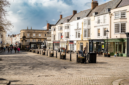 Wells, United Kingdom – March, 24 2023: View in and around High Street and Market Place in the Somerset town of Wells, England.