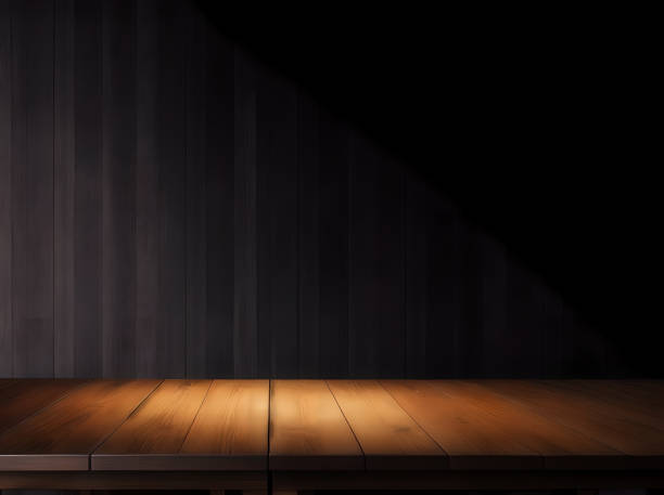 Wooden table with dark blurred background. stock photo
