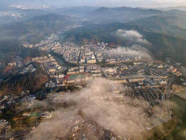 istock Clouds and mist over a small city in the mountain 1477527841