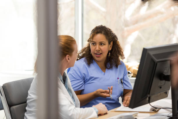 istock Doctor and surgeon analyze patient test results and symptoms 1477528363