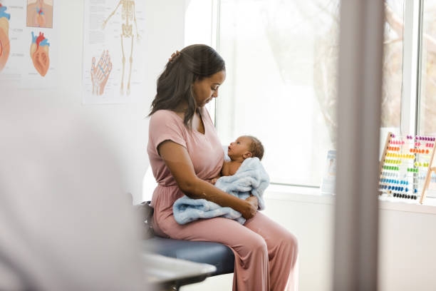 istock Unrecognizable doctor walks in as mom interacts with baby 1477528382