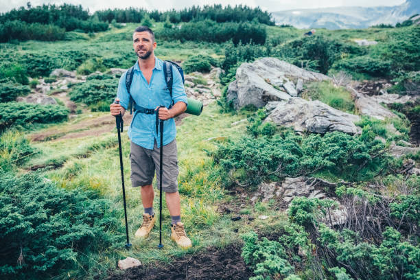 istock Tourist man hiking in the mountain 1477528456