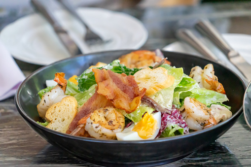 Delicious Caesar Salad with Grilled Chicken, Crispy Bacon, and Shrimp