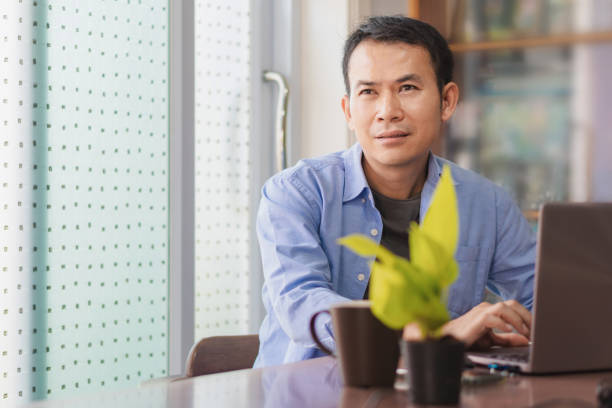 istock Asian man using laptop at home, Male hands typing on the notebook keyboard, Working from home concepts 1477530322