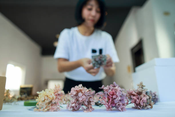 istock A female floral teacher is making a wreath using preserved hydrangeas 1477530687