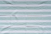 Striped linen background, green and white colors